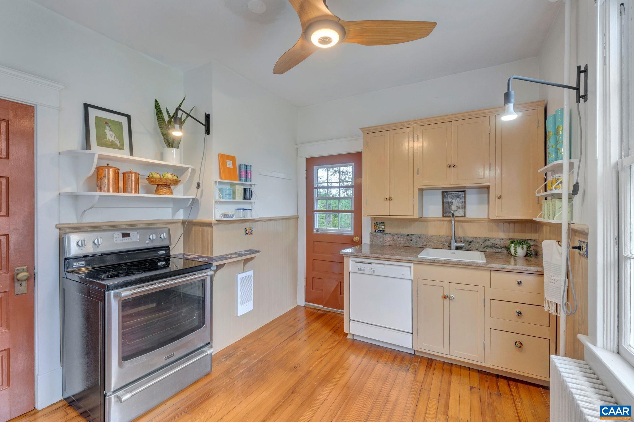 945 Locust Avenue Charlottesville, VA 22901 - Photo 15 of 52 a kitchen with stainless steel appliances a stove sink and cabinets
