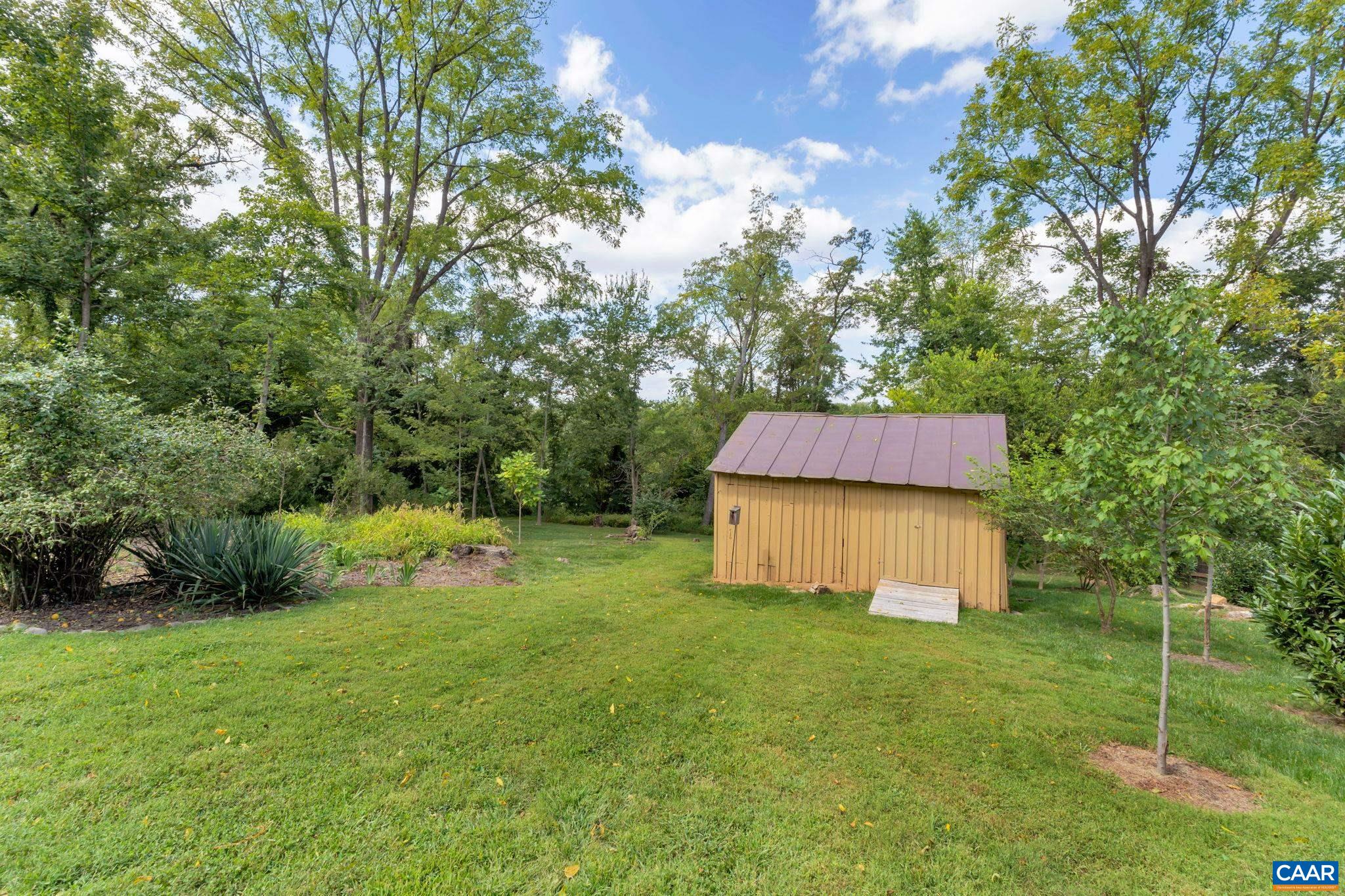 945 Locust Avenue Charlottesville, VA 22901 - Photo 2 of 52 a backyard of a house with table and chairs