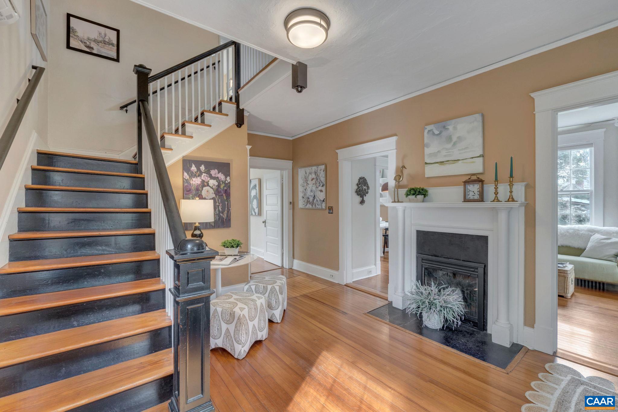 945 Locust Avenue Charlottesville, VA 22901 - Photo 22 of 52 a view of a livingroom with furniture wooden floor fireplace and windows