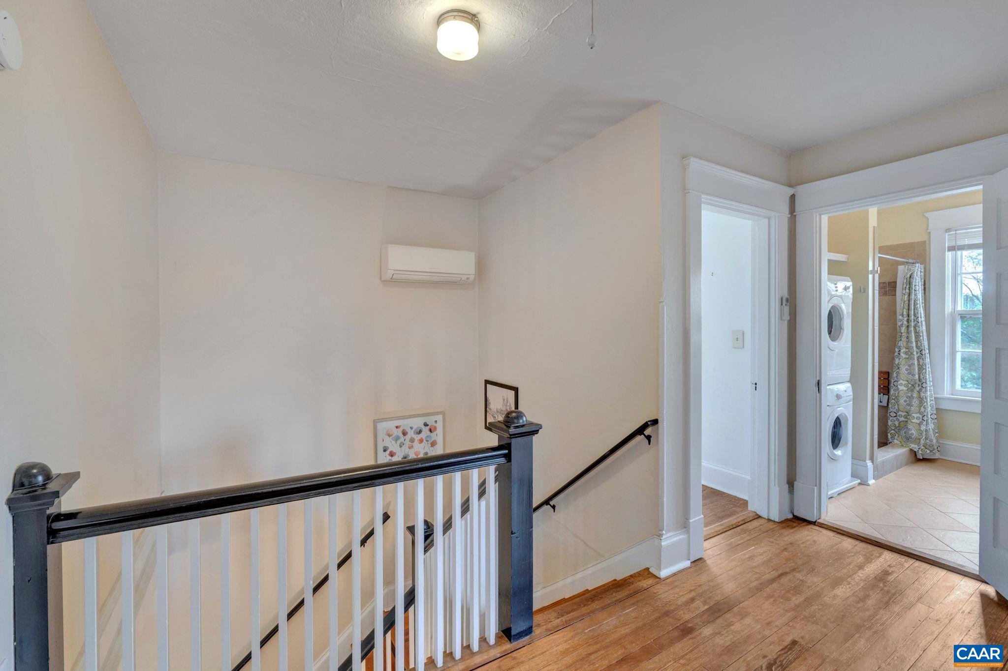 945 Locust Avenue Charlottesville, VA 22901 - Photo 23 of 52 a view of a hallway with wooden floor and staircase