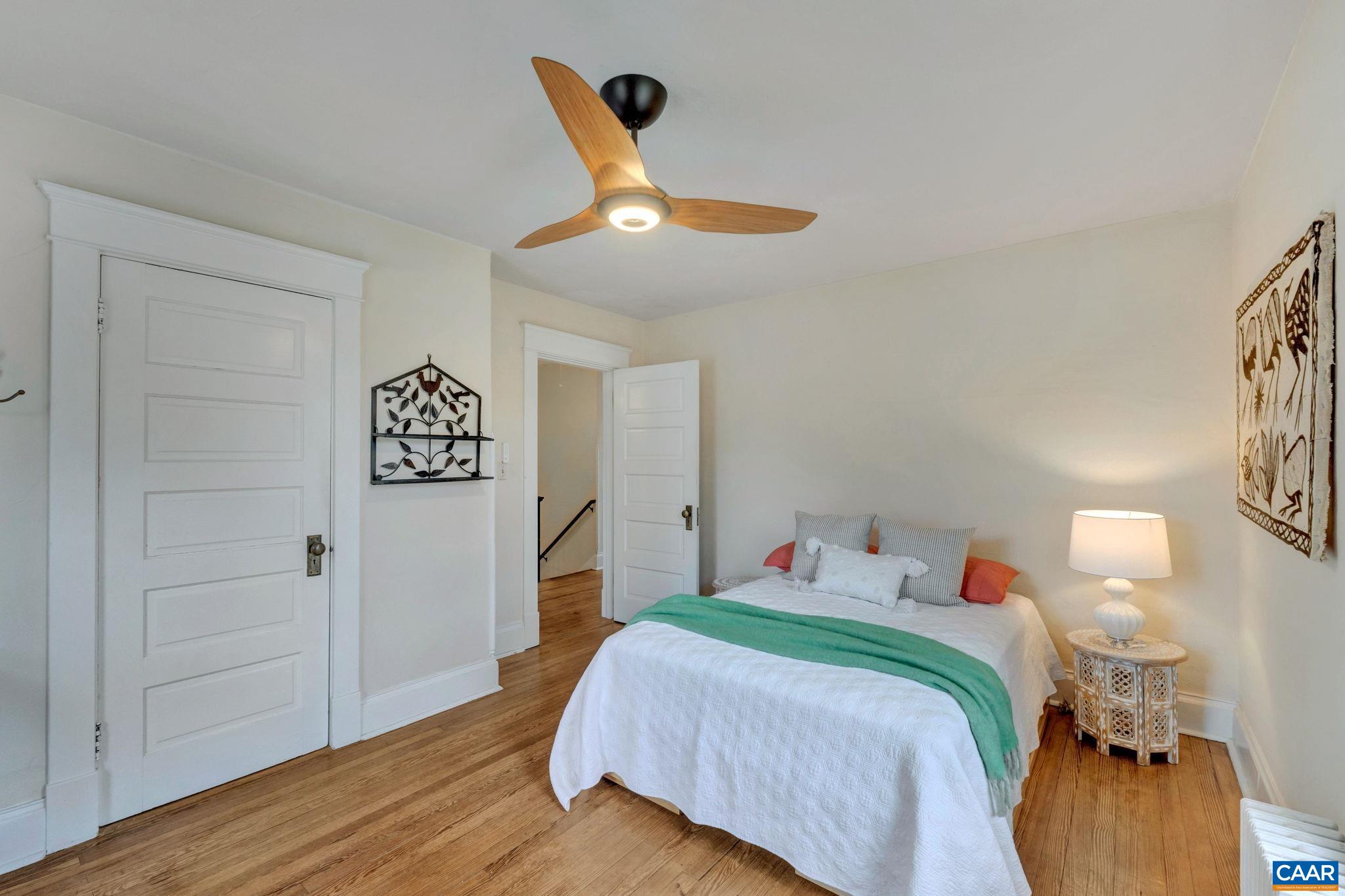 945 Locust Avenue Charlottesville, VA 22901 - Photo 25 of 52 a bedroom with a bed and a painting on the wall