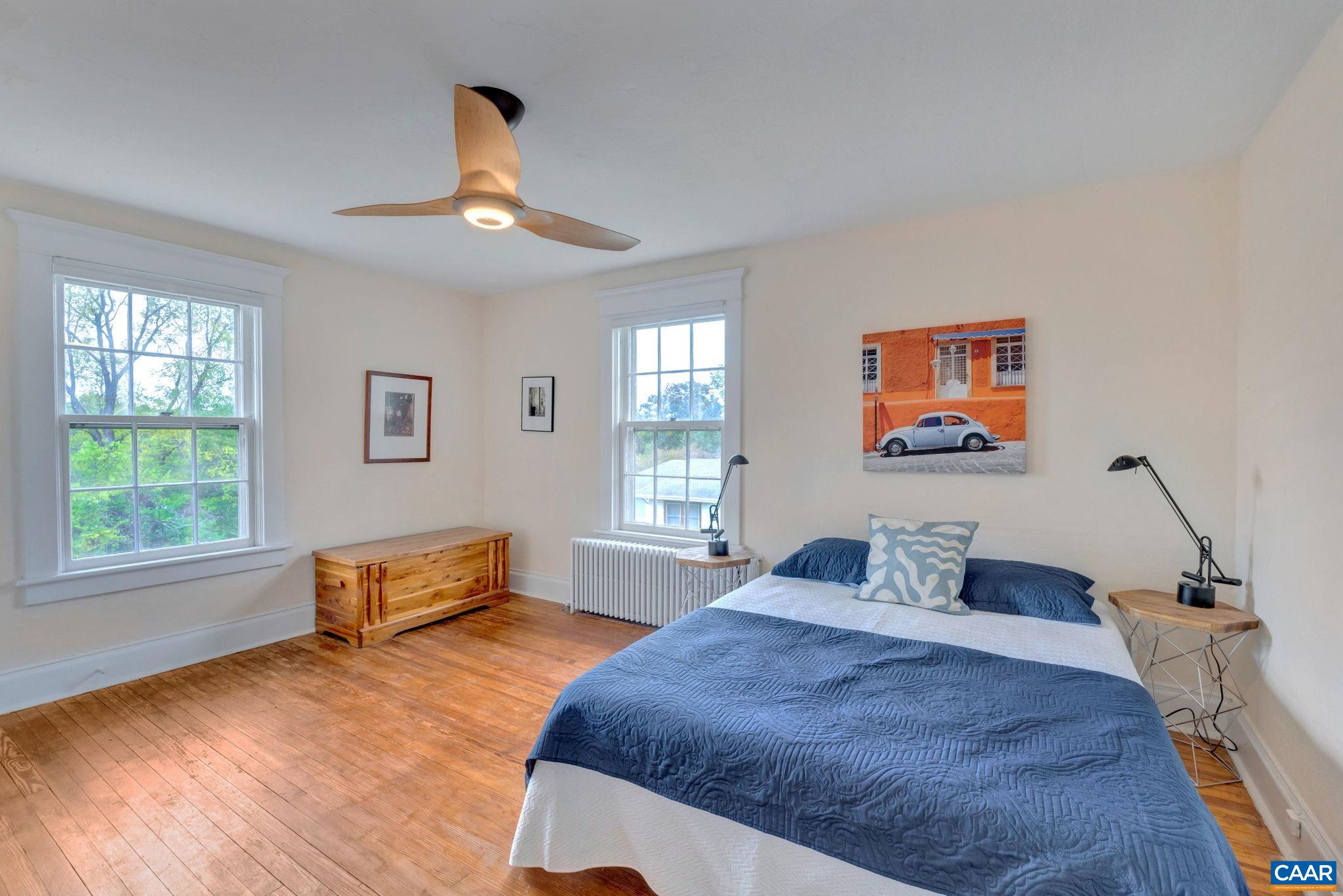 945 Locust Avenue Charlottesville, VA 22901 - Photo 26 of 52 a bedroom with a bed and wooden floor