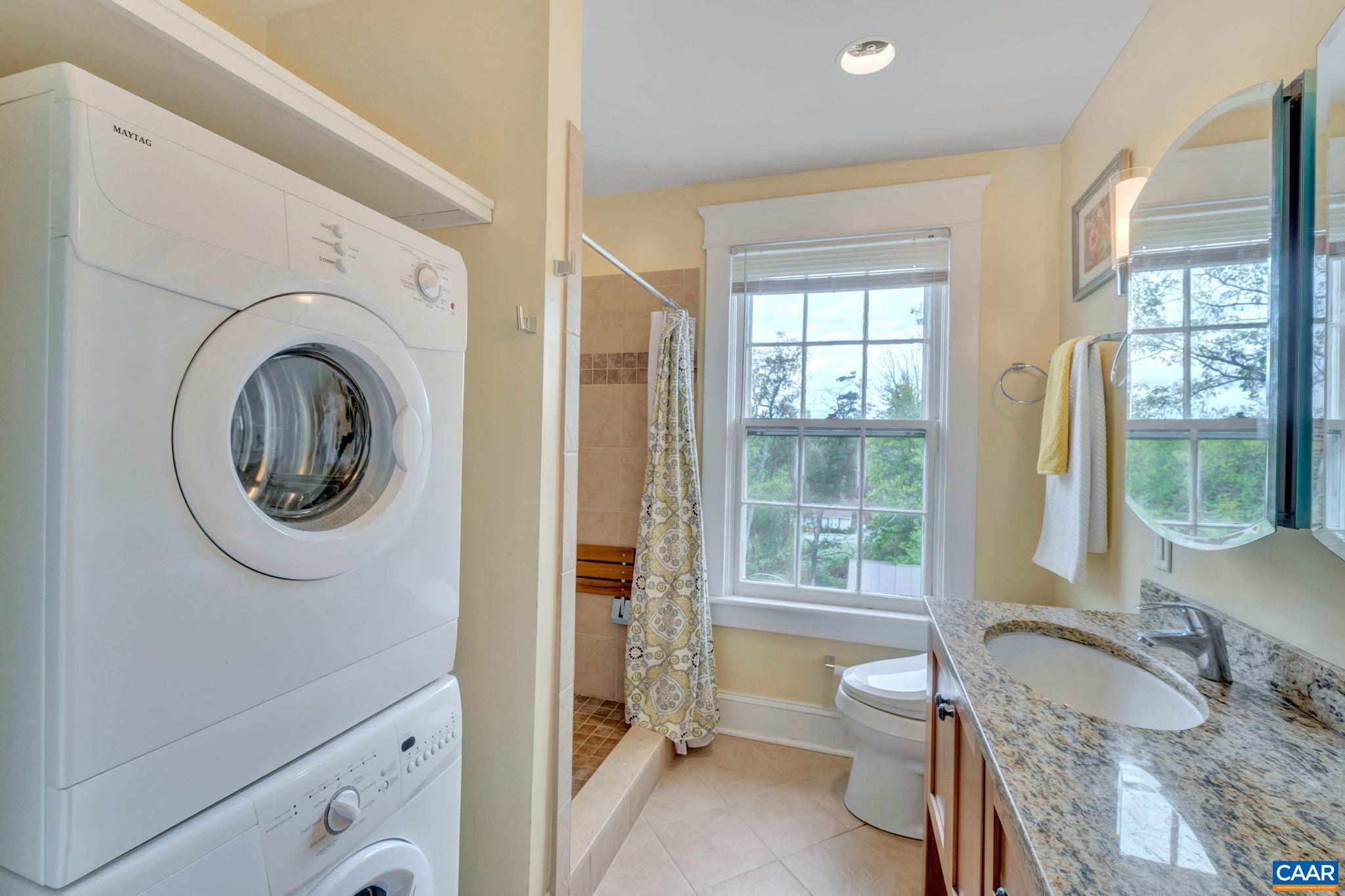 945 Locust Avenue Charlottesville, VA 22901 - Photo 27 of 52 a spacious bathroom with a granite countertop tub next to a large window