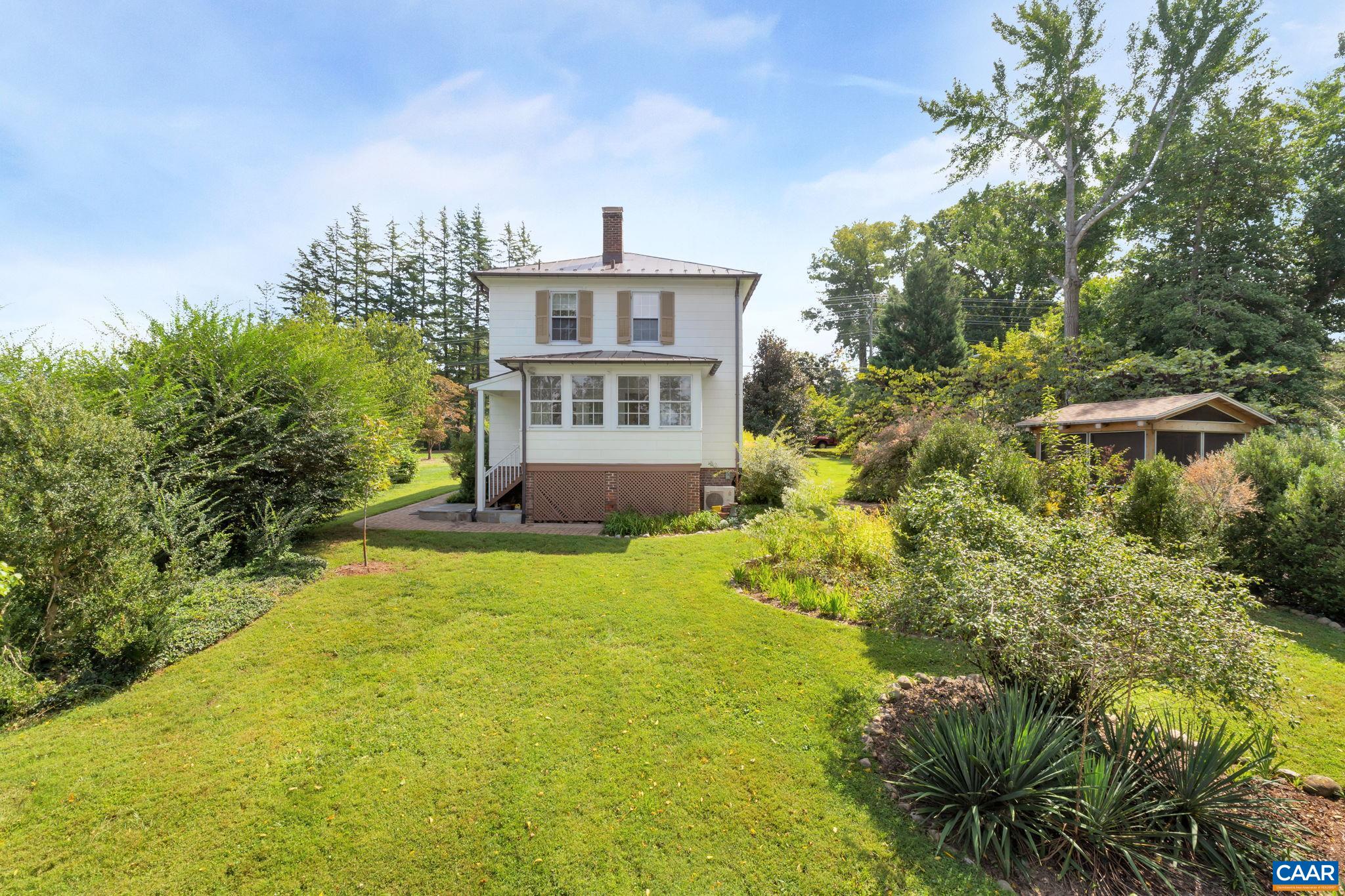 945 Locust Avenue Charlottesville, VA 22901 - Photo 4 of 52 a view of a house with a yard and potted plants