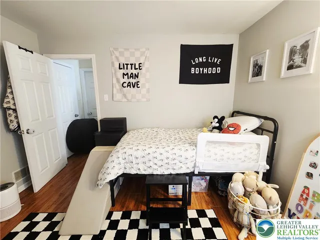 a bedroom with a bed window and wall painting