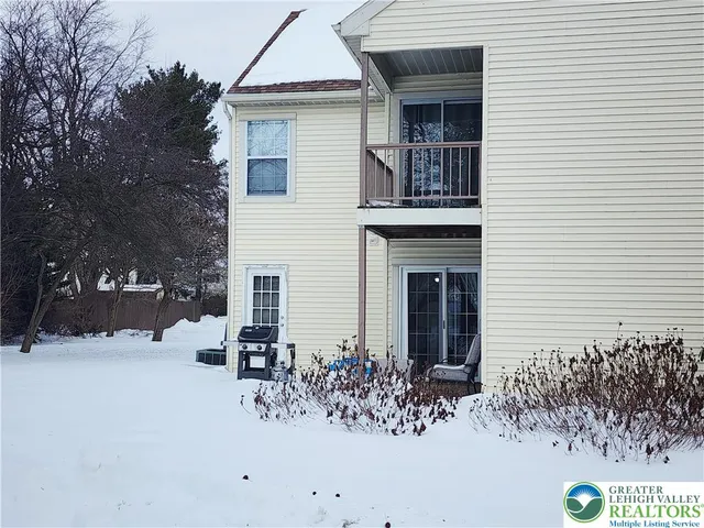 a view of a house with a snow in the yard