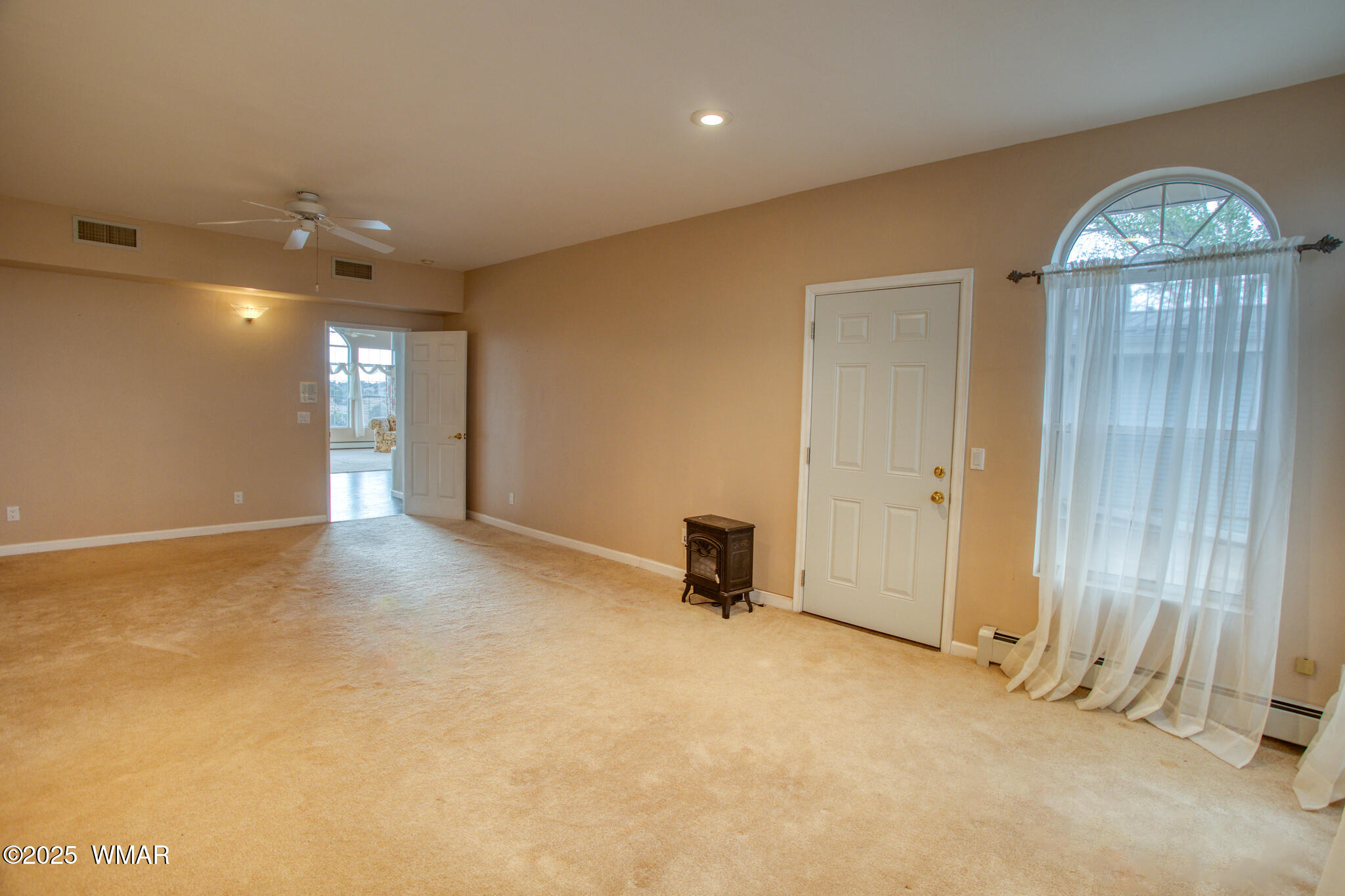 9410 Butler Trail Snowflake, AZ 85937 - Photo 33 of 62 an empty room with a chandelier fan and a window