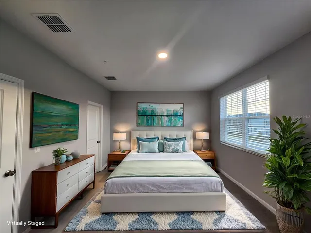 a spacious bedroom with a large bed and a flat screen tv