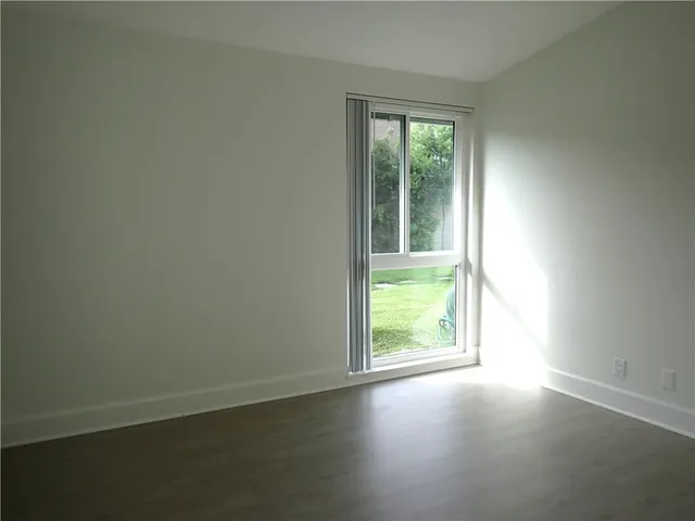 an empty room with a empty space and a window
