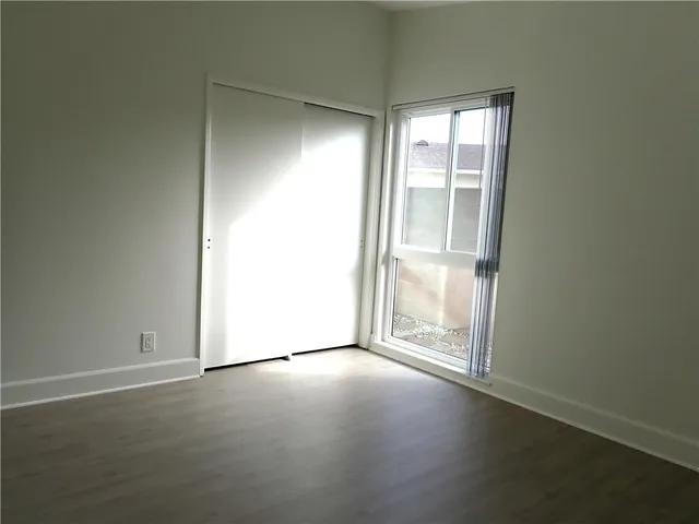 a bathroom with a granite countertop toilet sink and mirror