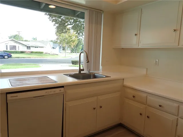 a kitchen with a sink and large window