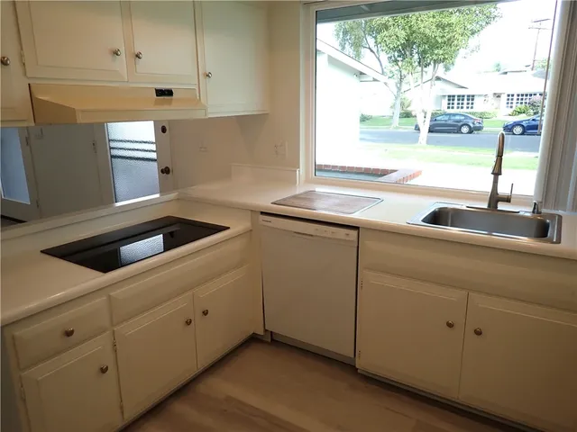 a kitchen with white cabinets and a sink