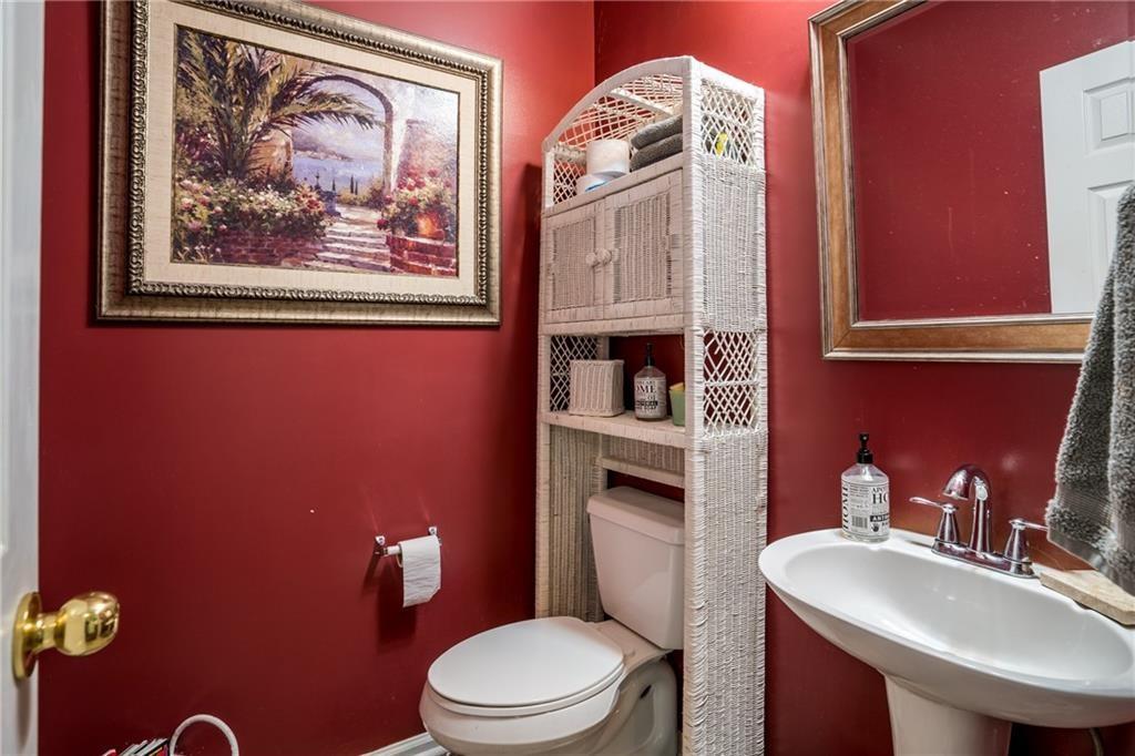 5160 Lakeview Parkway Villa Rica, GA 30180 - Photo 12 of 44 a bathroom with a toilet a sink and mirror