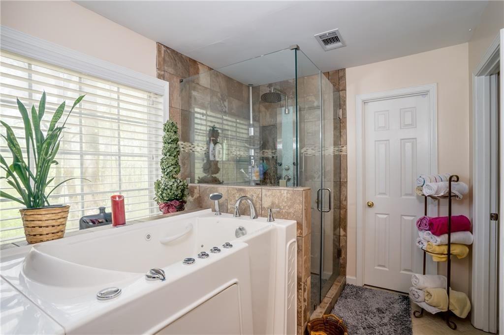 5160 Lakeview Parkway Villa Rica, GA 30180 - Photo 14 of 44 a bath tub sitting in a bathroom next to a window