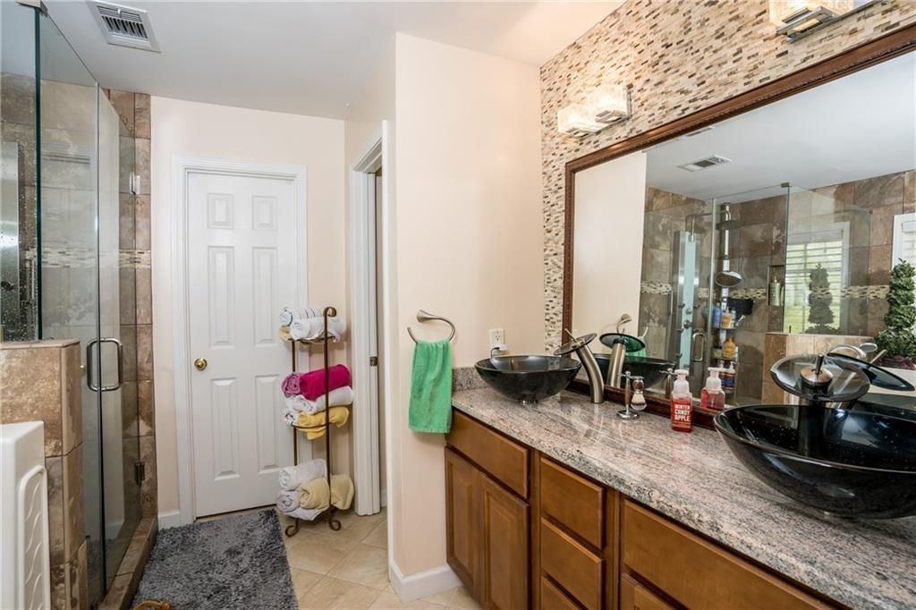 5160 Lakeview Parkway Villa Rica, GA 30180 - Photo 15 of 44 a view of a bathroom with a sink and mirror