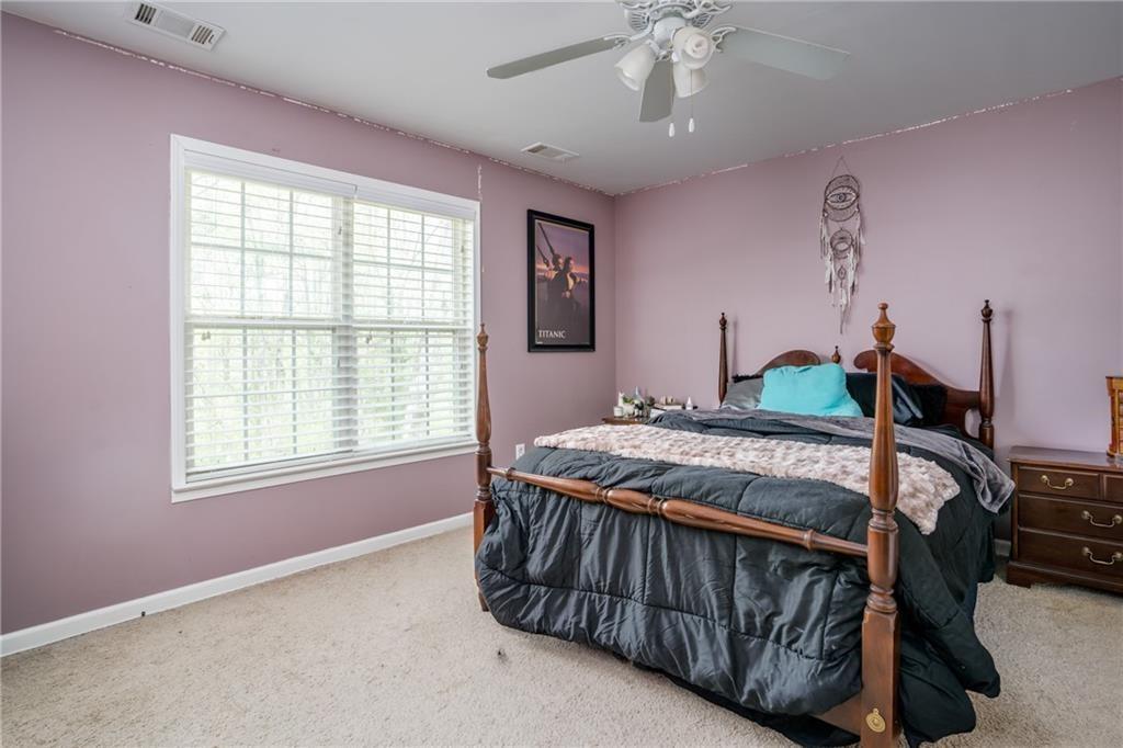5160 Lakeview Parkway Villa Rica, GA 30180 - Photo 19 of 44 a bedroom with a bed and a chandelier