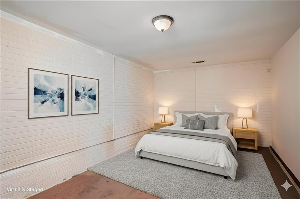 5160 Lakeview Parkway Villa Rica, GA 30180 - Photo 26 of 44 a bedroom with a bed and painting on the wall