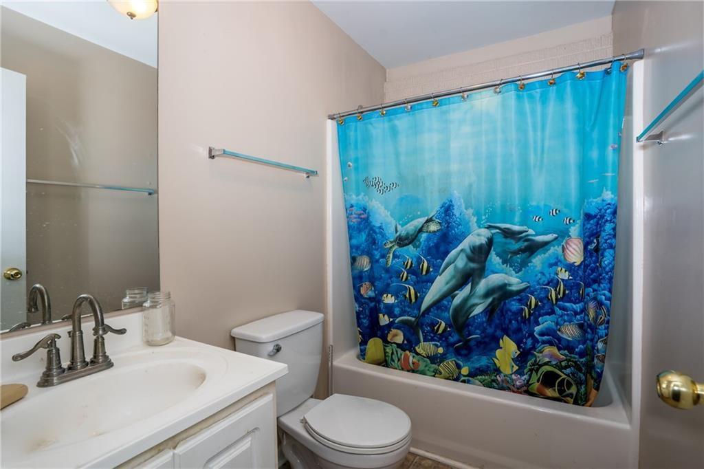 5160 Lakeview Parkway Villa Rica, GA 30180 - Photo 27 of 44 a bathroom with a toilet sink and shower curtain