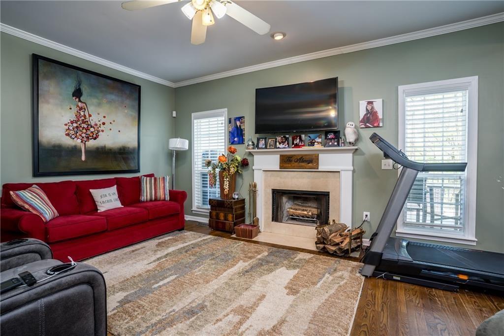 5160 Lakeview Parkway Villa Rica, GA 30180 - Photo 5 of 44 a living room with furniture a fireplace and a flat screen tv