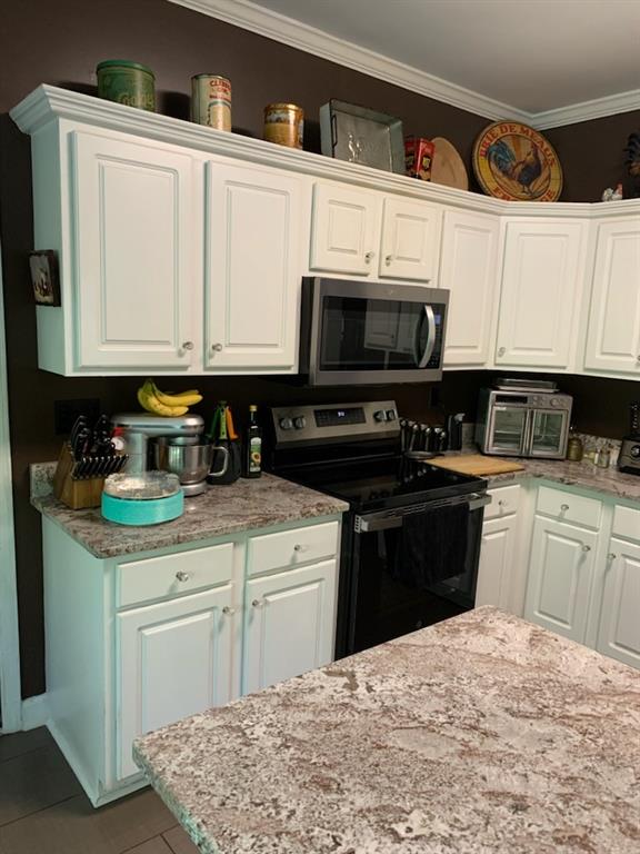 5160 Lakeview Parkway Villa Rica, GA 30180 - Photo 8 of 44 a kitchen with stainless steel appliances granite countertop a stove a sink and a microwave