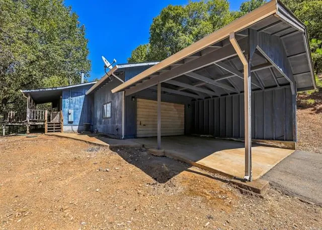 a backyard of a house with table and chairs