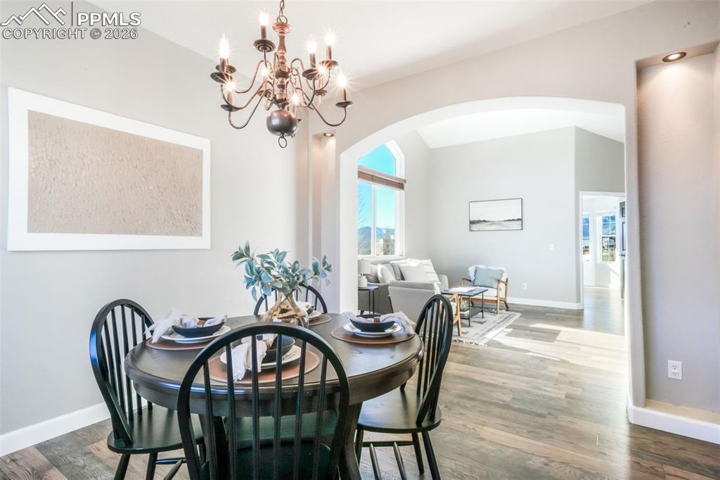 1675 Bowstring Road Monument, CO 80132 - Photo 11 of 50 a view of a dining room with furniture and chandelier