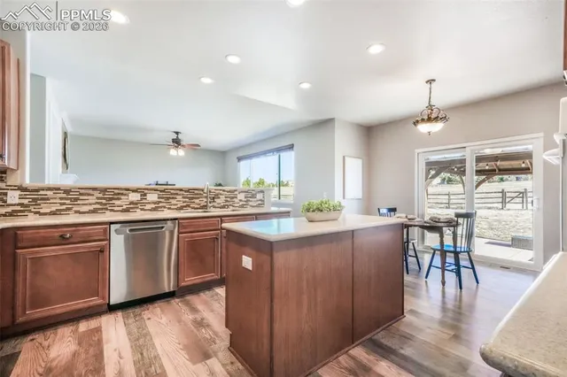 a kitchen with lots of counter top space and dining table