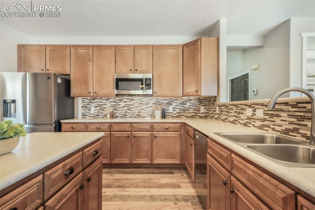 1675 Bowstring Road Monument, CO 80132 - Photo 17 of 50 a kitchen with a sink stove and refrigerator