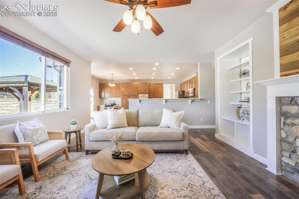1675 Bowstring Road Monument, CO 80132 - Photo 19 of 50 a living room with furniture kitchen view and a large window