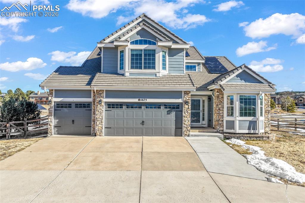 1675 Bowstring Road Monument, CO 80132 - Photo 2 of 50 a front view of a house with a garage