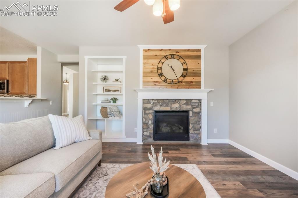 1675 Bowstring Road Monument, CO 80132 - Photo 23 of 50 a living room with furniture and a fireplace
