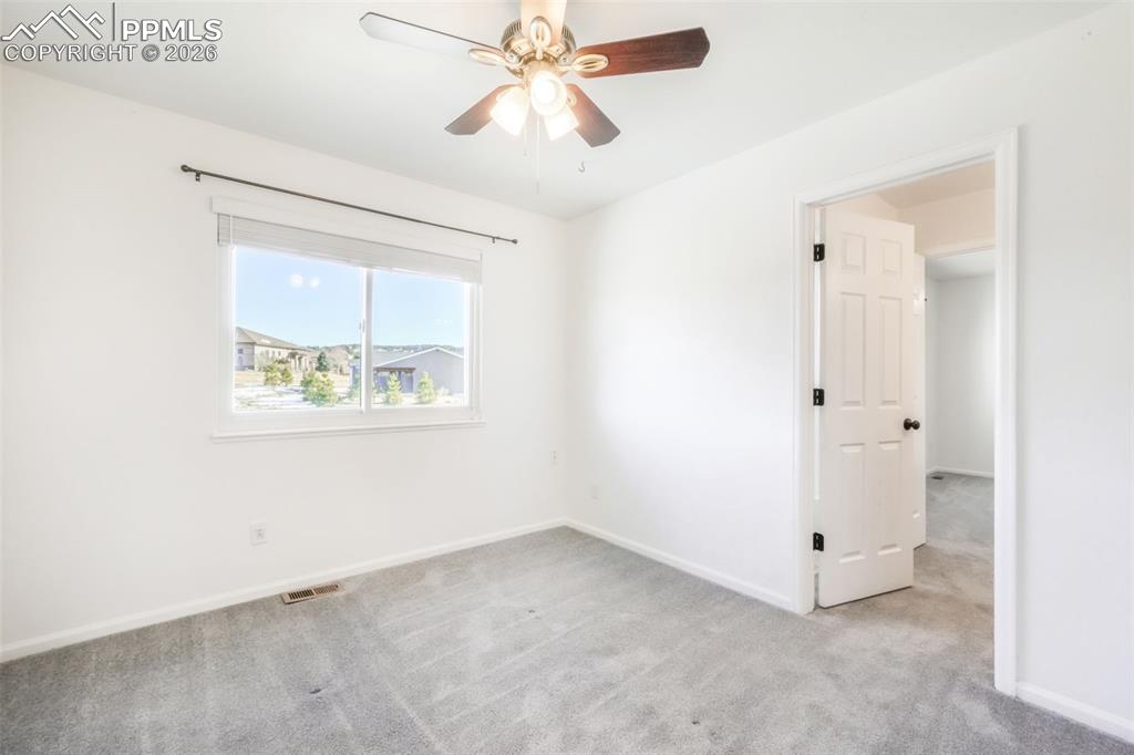 1675 Bowstring Road Monument, CO 80132 - Photo 27 of 50 an empty room with windows and fan
