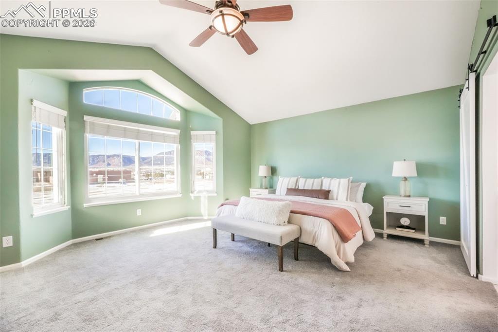 1675 Bowstring Road Monument, CO 80132 - Photo 34 of 50 a spacious bedroom with a bed and a window