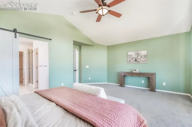 a bedroom with a bed and a bathroom