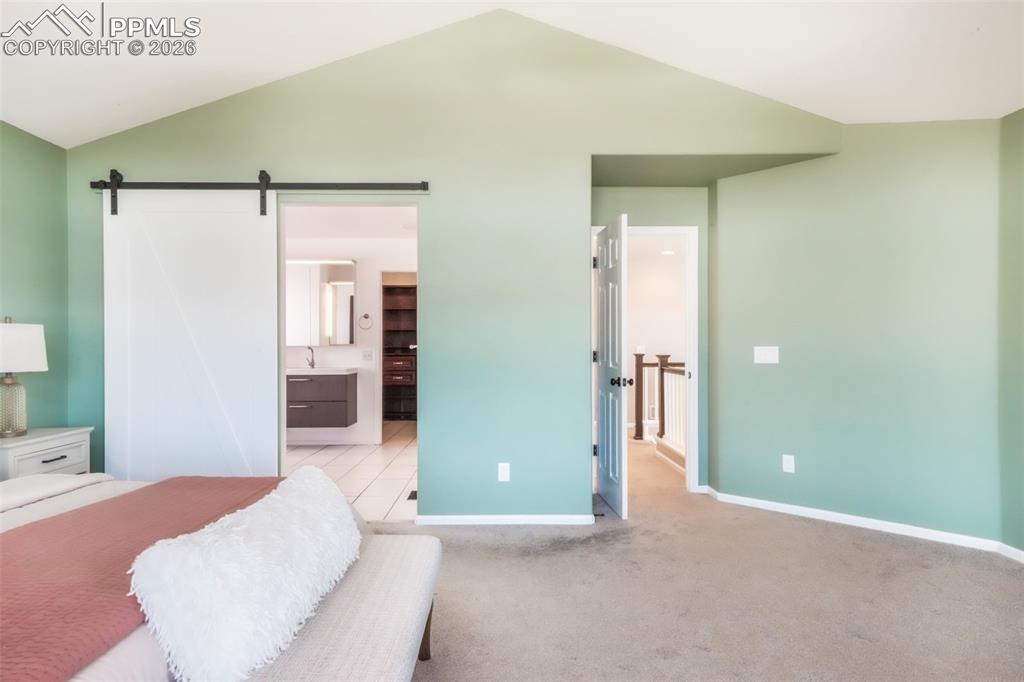 1675 Bowstring Road Monument, CO 80132 - Photo 37 of 50 a bedroom with a bed and a bathroom