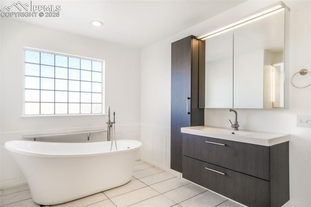 1675 Bowstring Road Monument, CO 80132 - Photo 38 of 50 a bathroom with a bathtub and a sink