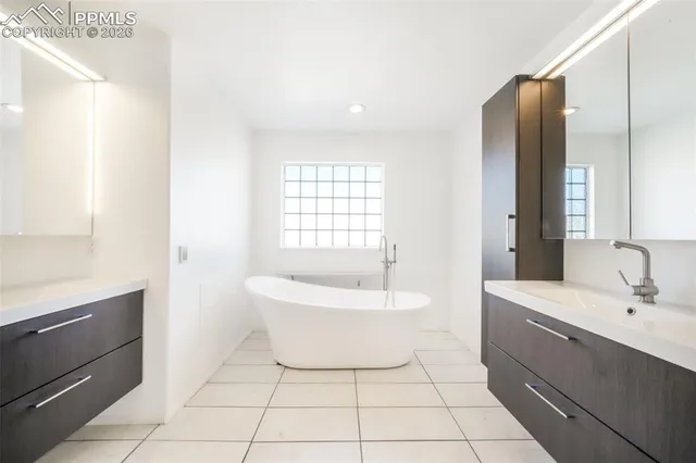 a bathroom with a shower a sink and a mirror