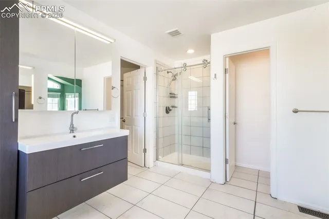a spacious bathroom with a bathtub sink and mirror