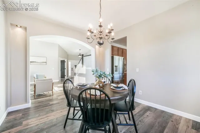 a view of a dining room with furniture and a chandelier