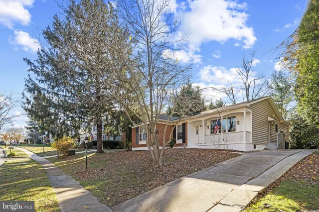 a view of a white house with a yard