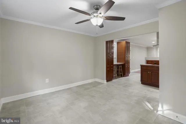 an empty room with closet and windows