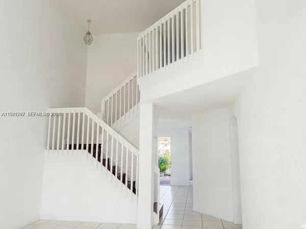 a view of staircase with white walls and a window