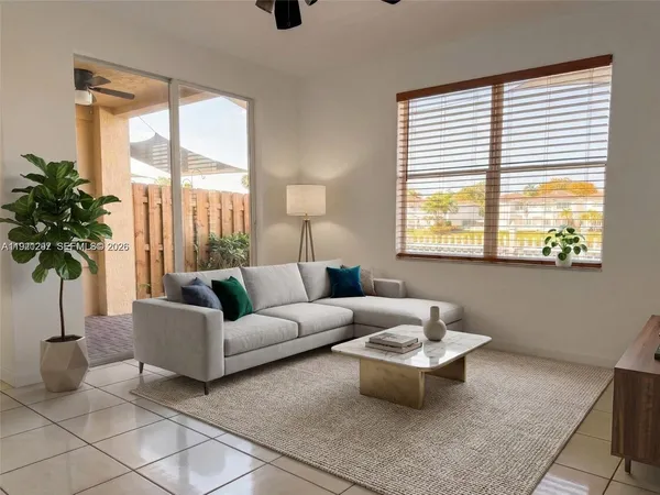a living room with furniture and a large window