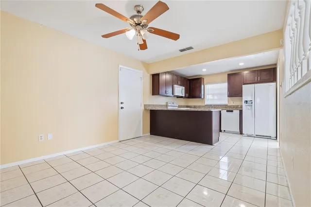 a open kitchen with cabinets and stainless steel appliances