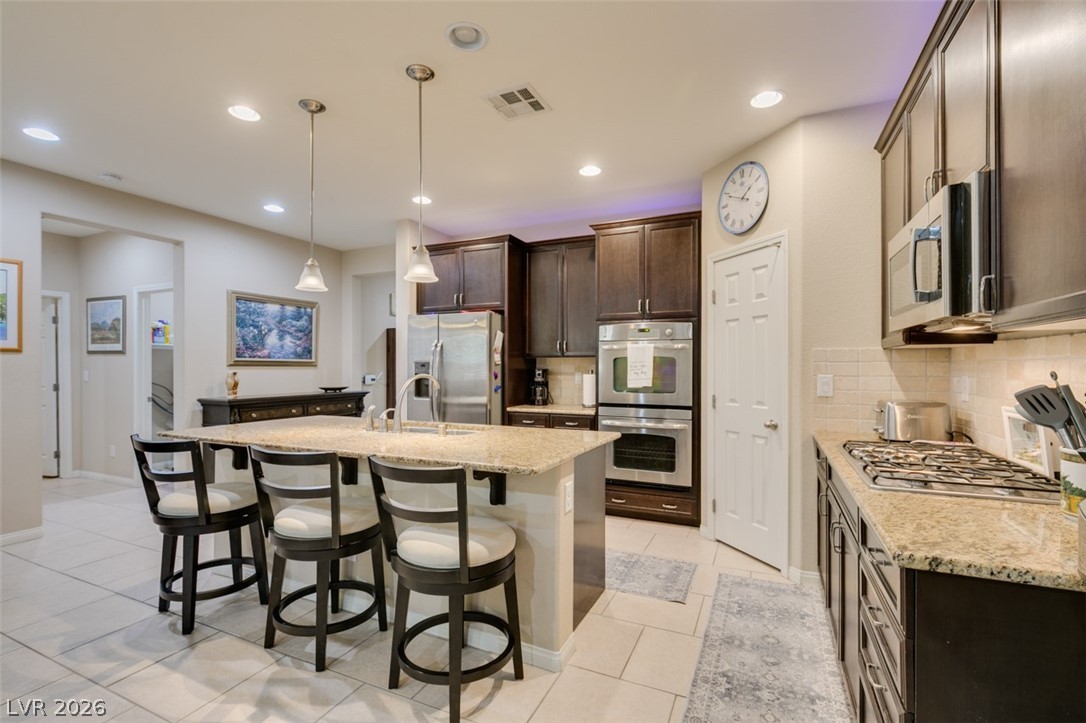 7375 Campbell Ranch Avenue Las Vegas, NV 89179 - Photo 13 of 45 Culinary delights await in this modern kitchen with extensive counter space and an inviting island.