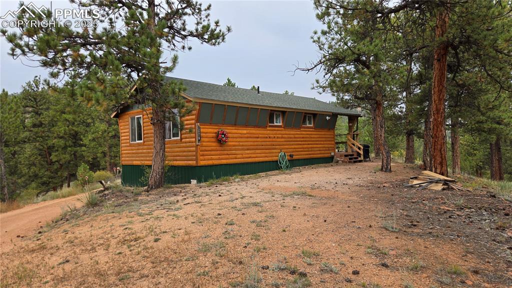 259 Vermillion Road Lake George, CO 80827 - Photo 22 of 46 a front view of a house with a yard