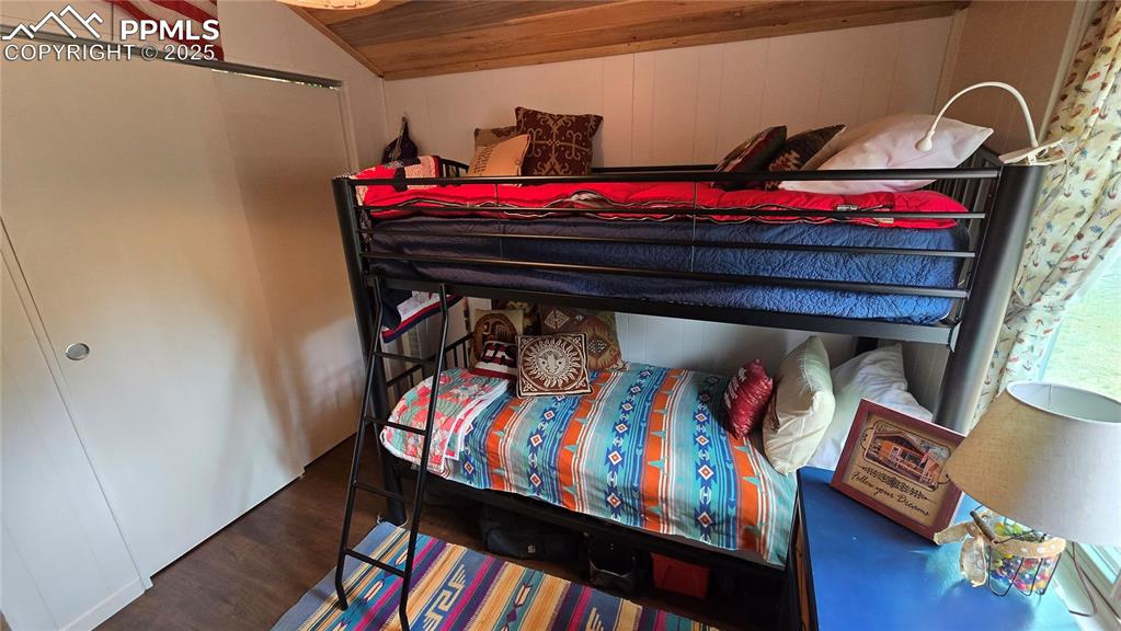 259 Vermillion Road Lake George, CO 80827 - Photo 34 of 46 a bed room with a bed a desk and a book shelf