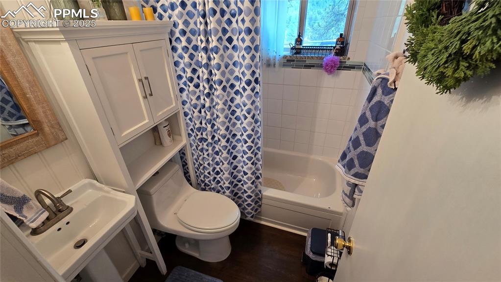 259 Vermillion Road Lake George, CO 80827 - Photo 5 of 46 a white toilet sitting next to a shower curtain