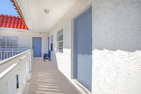a view of a hallway with wooden floor and entryway