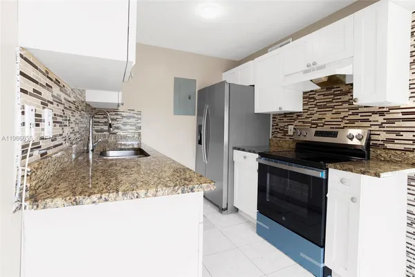 a kitchen with a stove and a refrigerator
